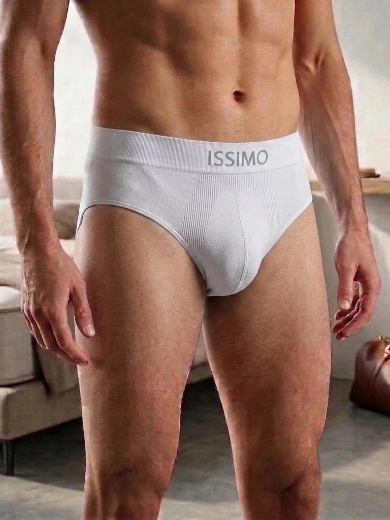 A close-up of a man wearing white ISSIMO men's briefs, showing the front waistband with the brand name printed in gray.